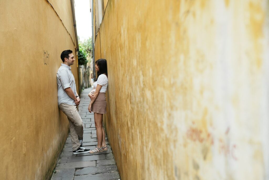 Couple standing in a narrow alleyway